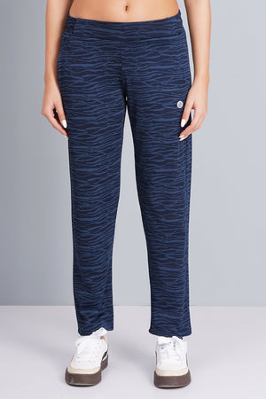 Person wearing blue patterned pants on a gray background