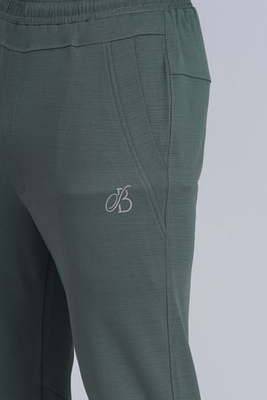 Green pants with a logo on a light gray background