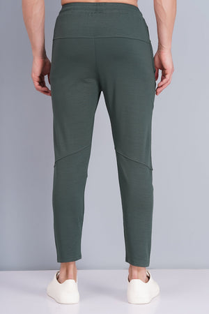 Green pants worn by a person on a gray background