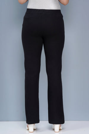 Black pants worn by a person on a gray background