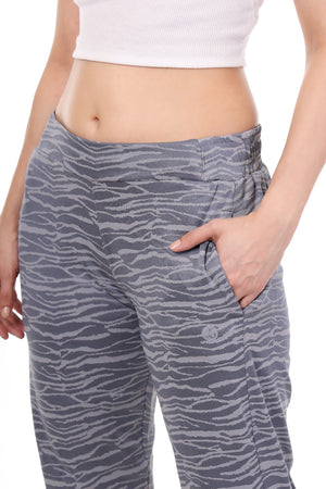 Gray zebra print pants worn by a person on a white background