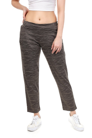 Person wearing gray patterned pants on a white background