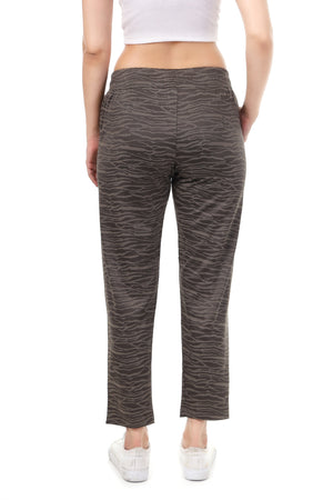 Person wearing gray patterned pants on a white background