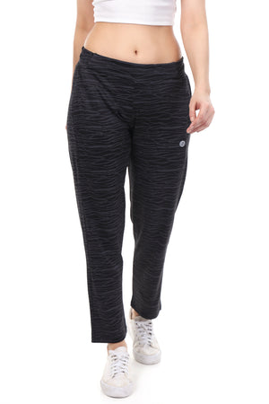 Person wearing black patterned pants on a white background