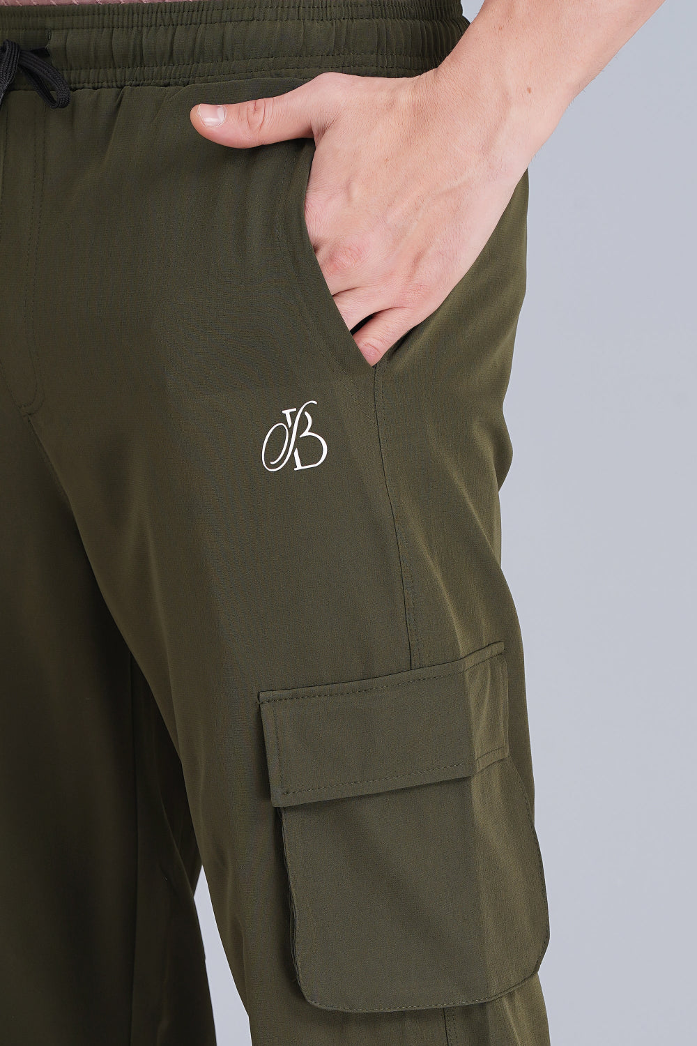 Green cargo pants with a logo on a plain background