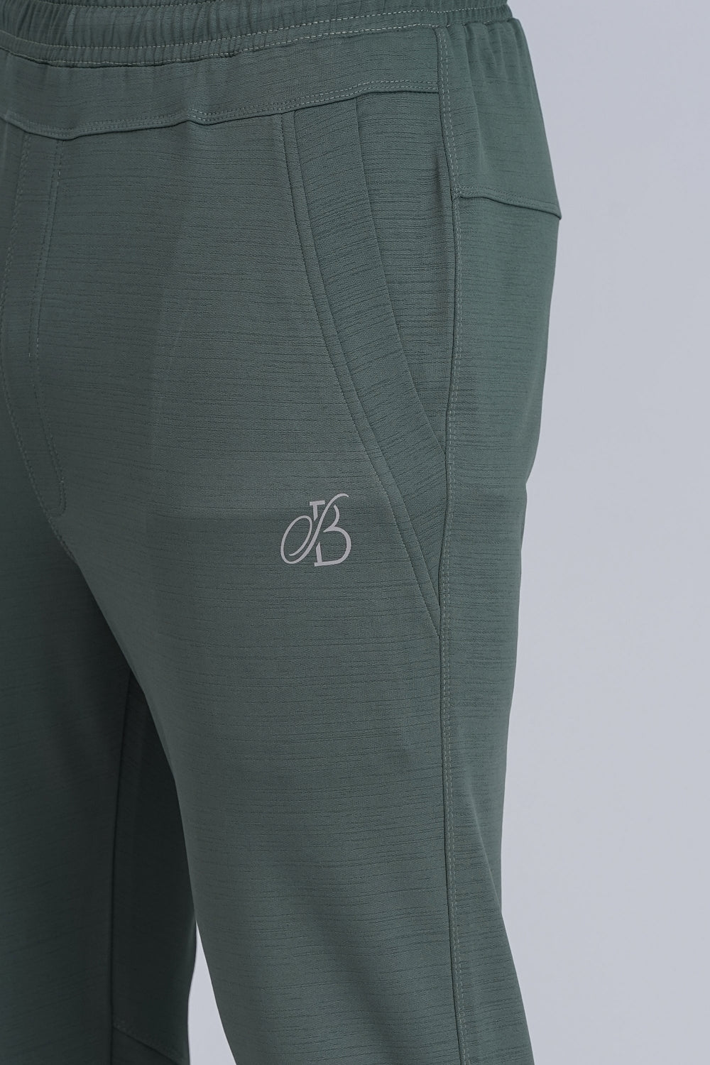 Green pants with a logo on a light gray background