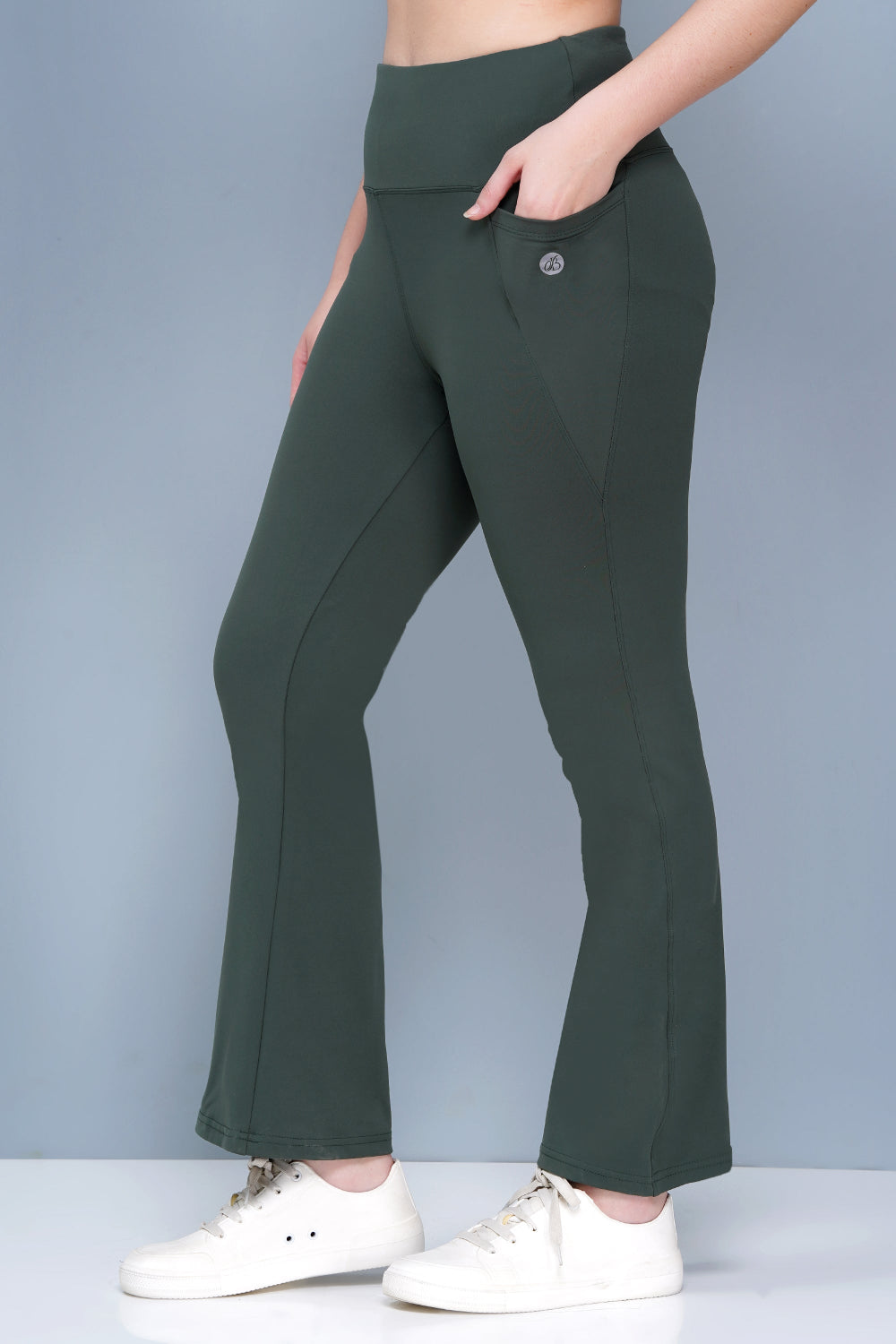 Green pants worn by a person on a gray background