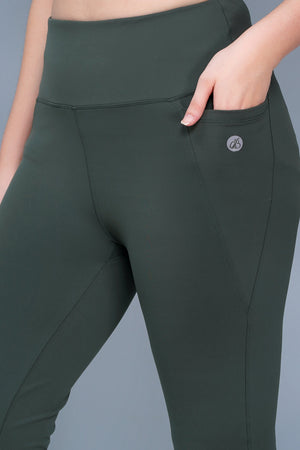 Dark green leggings with a brand logo on a gray background