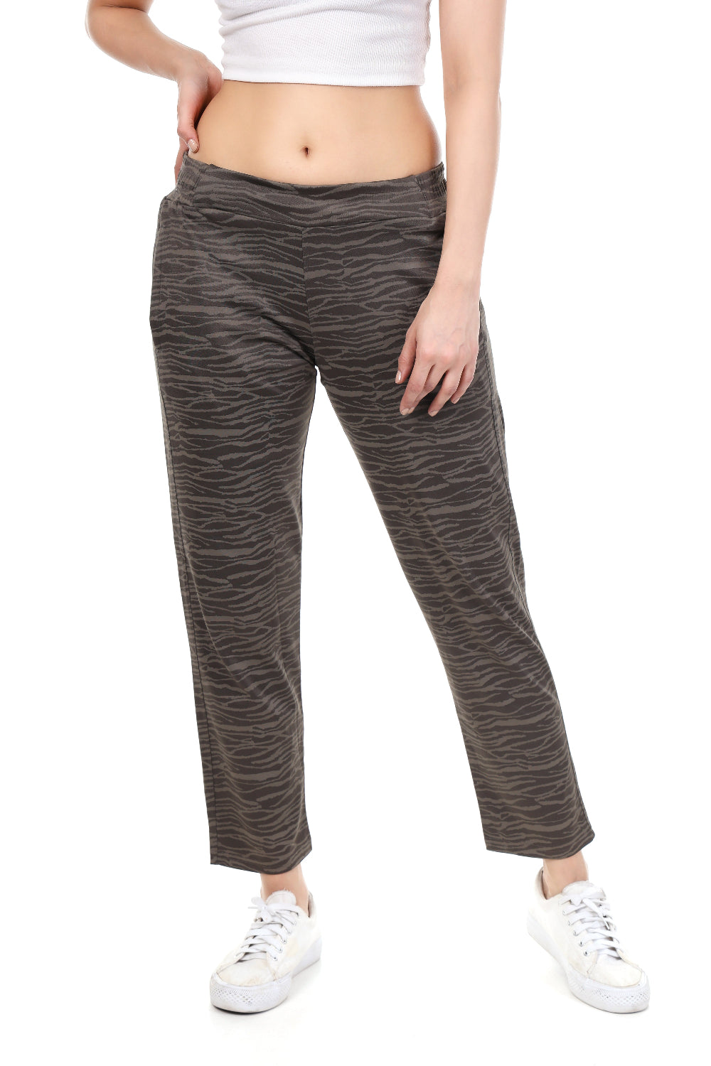 Person wearing gray patterned pants on a white background