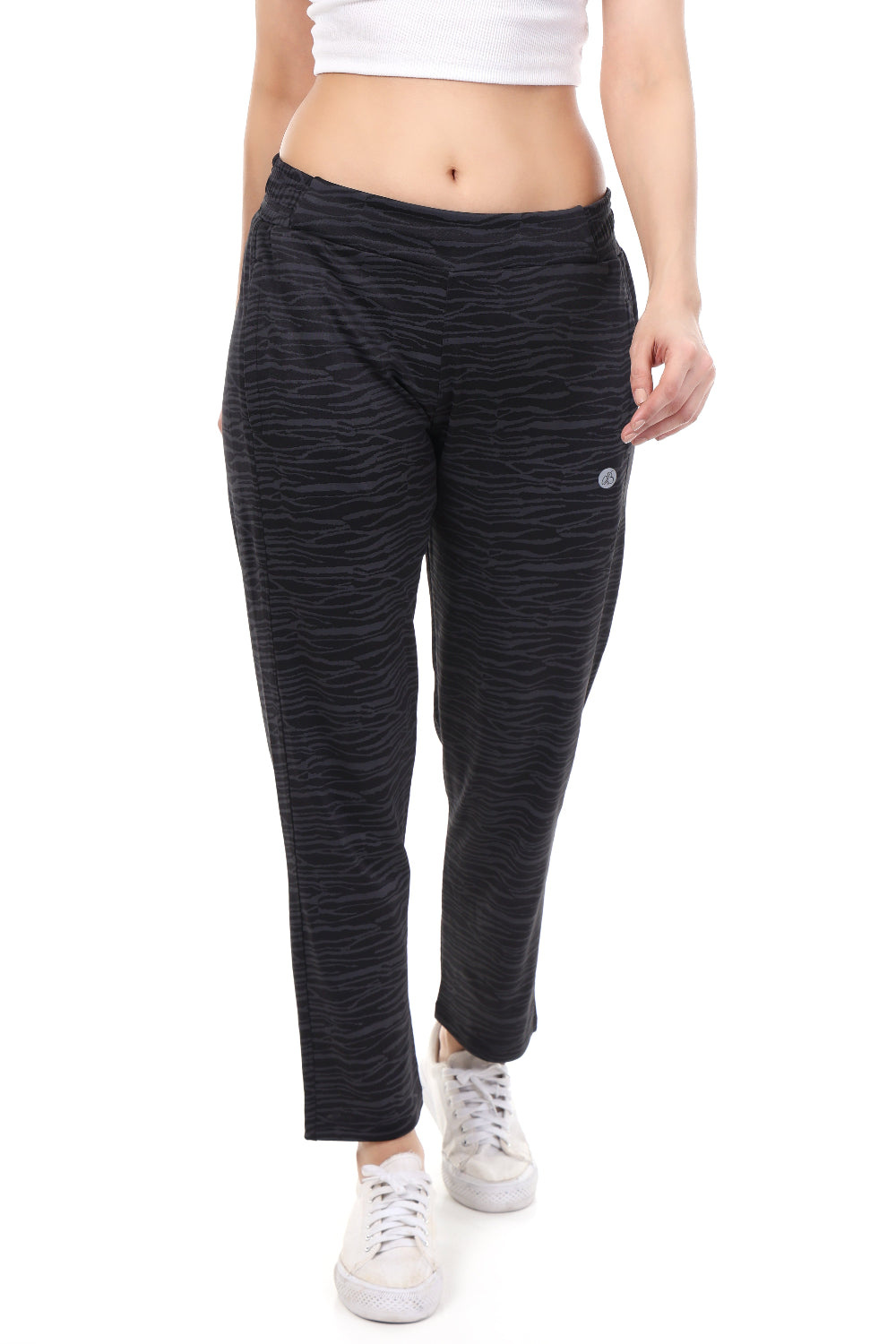 Person wearing black patterned pants on a white background