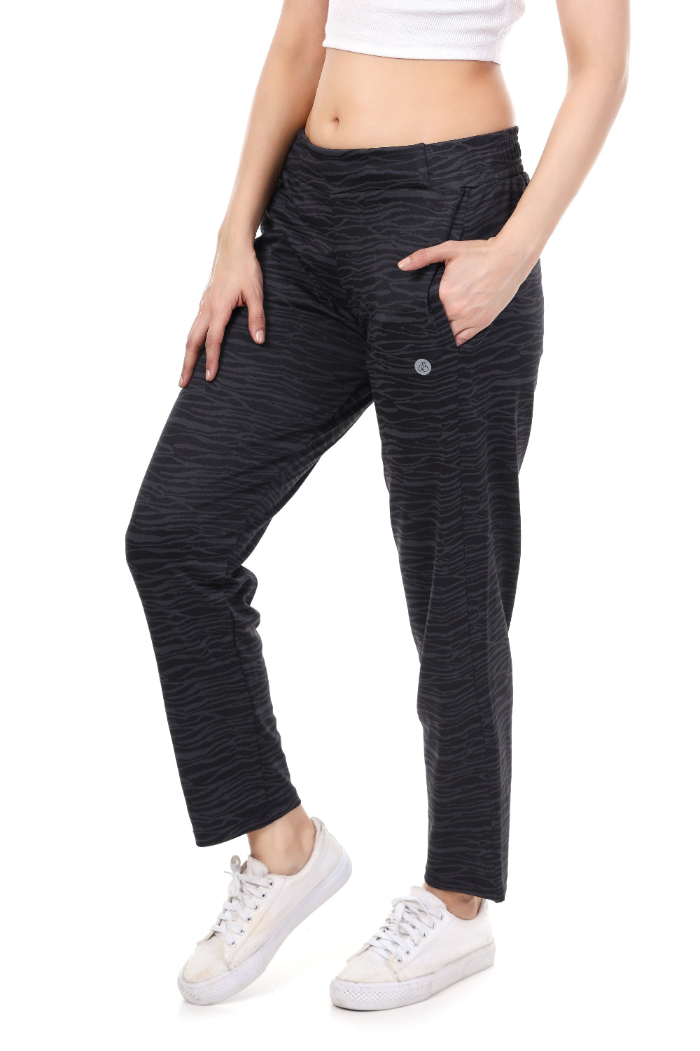 Person wearing black patterned pants on a white background