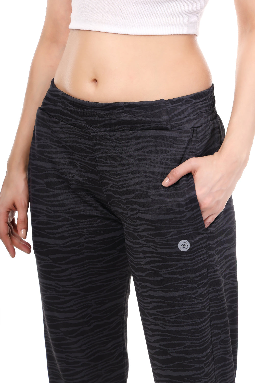 Black patterned pants worn by a person on a white background