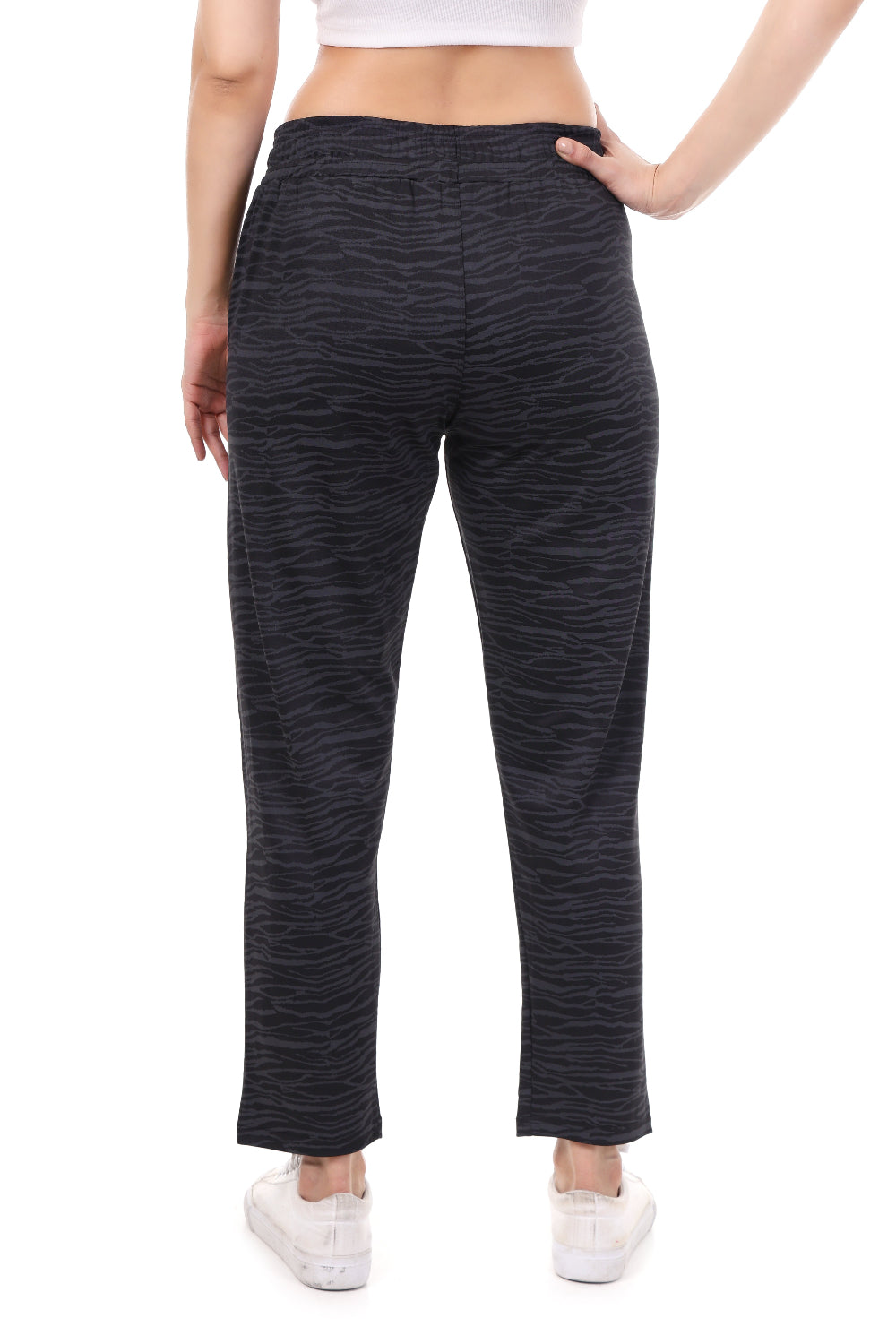 Black textured pants worn by a person on a white background