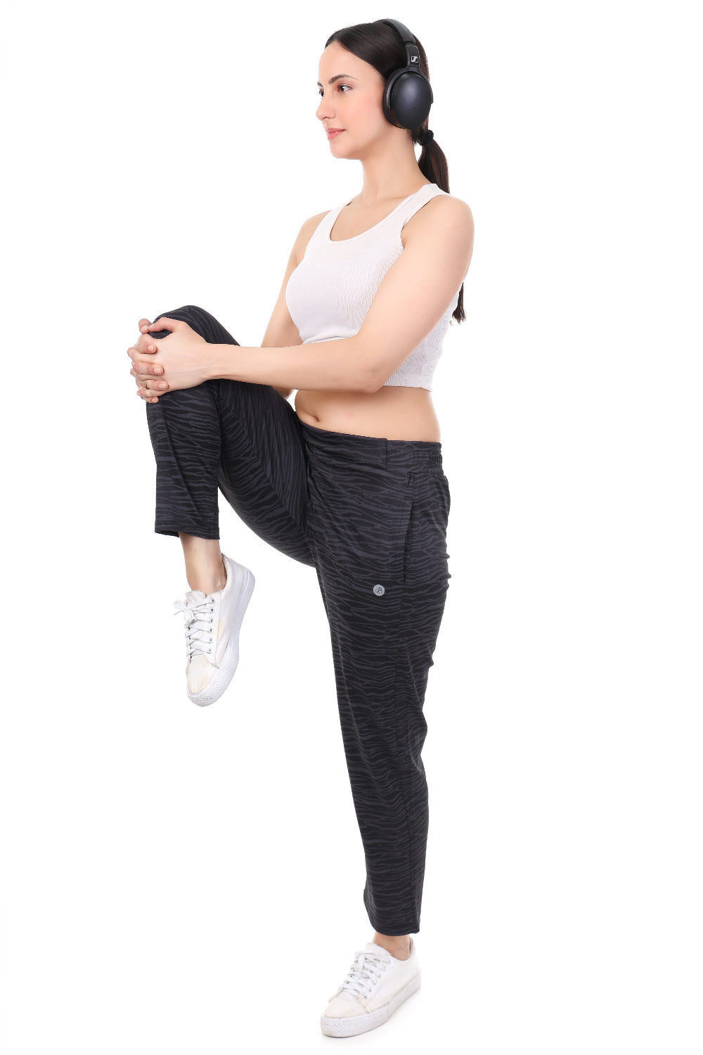 Woman stretching with headphones on a white background